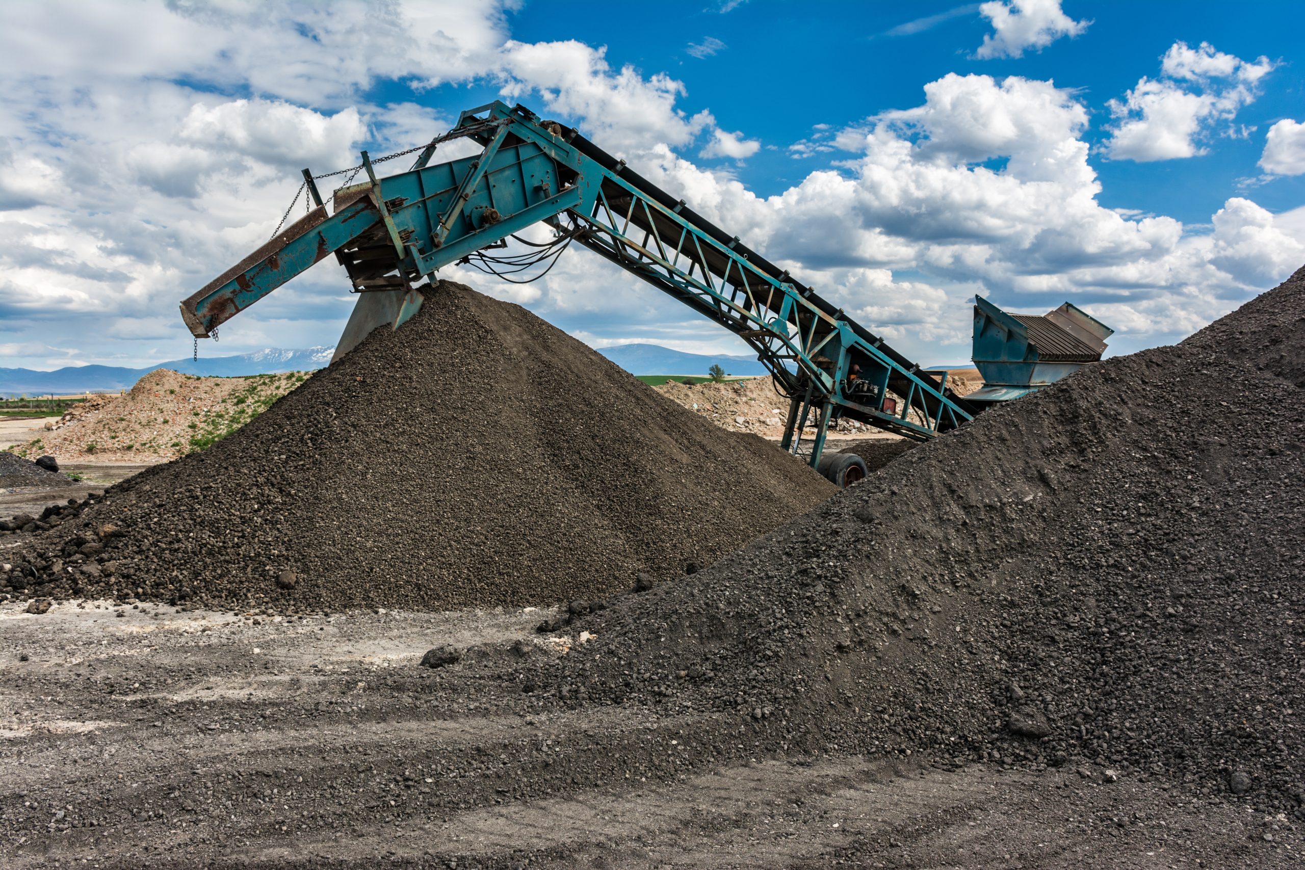 Recycling plant. Transforming asphalt from a gravel road to the construction of a new highway